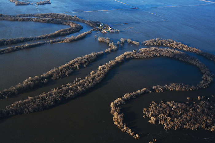 America Agriculture   Late afternoon aerial view of flooded farmland, a partially flooded farmstead and the Red River in flood stage   north of Fargo, North Dakota, USA., by Richard Hamilton Smith   Design Pics