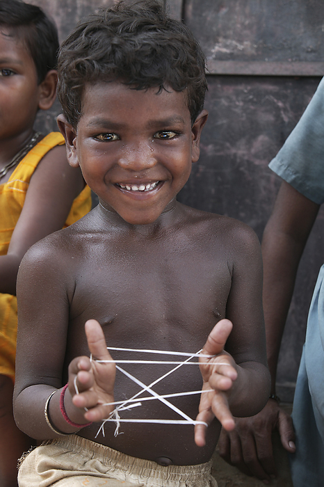 India A Child Plays Cats Cradle With String  India, by Jim Holmes   Design Pics