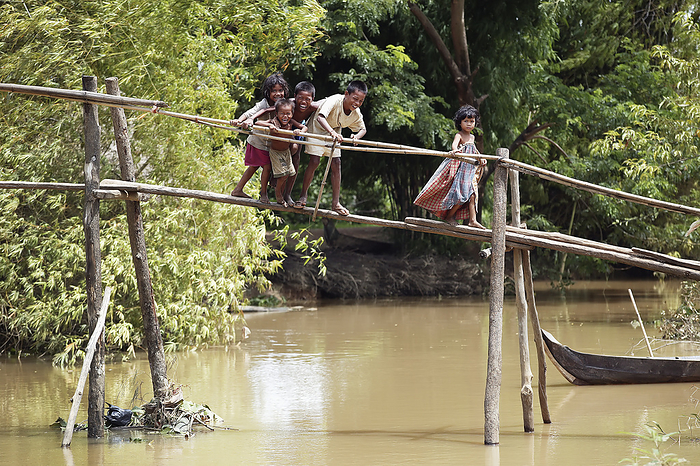 Cambodia Children Play On A Locally Made Bridge Across The Stream That Runs In Tone Sap Lake  Prek Chhdor Village, Battambang Province, Cambodia, by Jim Holmes   Design Pics