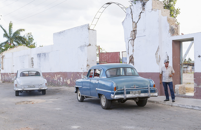 Cuba A Street View Of Cuba With Vintage Cars Parked Alongside Run Down Buildings And A Middle Aged Man Standing On The Sidewalk  Matanzas, Cuba, by Alanna Dumonceaux   Design Pics