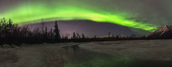 Panoramic View Of The Aurora Borealis Over The Frozen Knik River With Pioneer Peak In The Background., by Carl Johnson / Design Pics