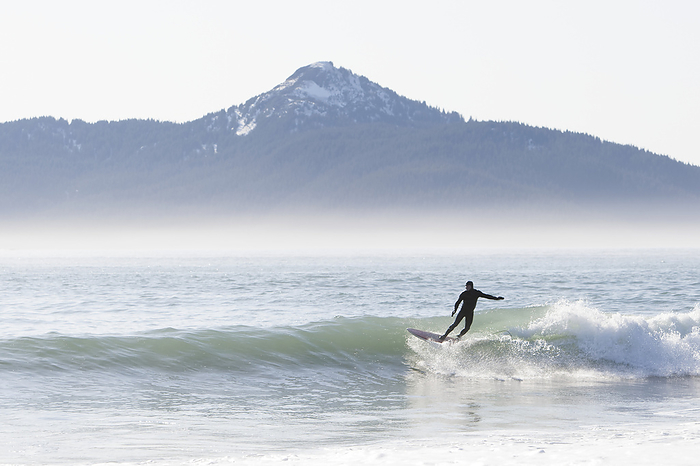 America Surfer riding a wave along the Kenai Peninsula Outer Coast, South central Alaska, USA, by Scott Dickerson   Design Pics