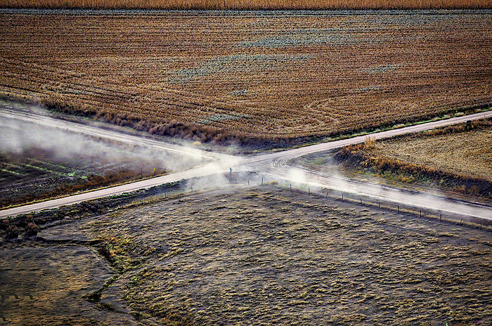 A dry wheat field between two feedlots.; Imperial, Nebraska., by Randy Olson / Design Pics