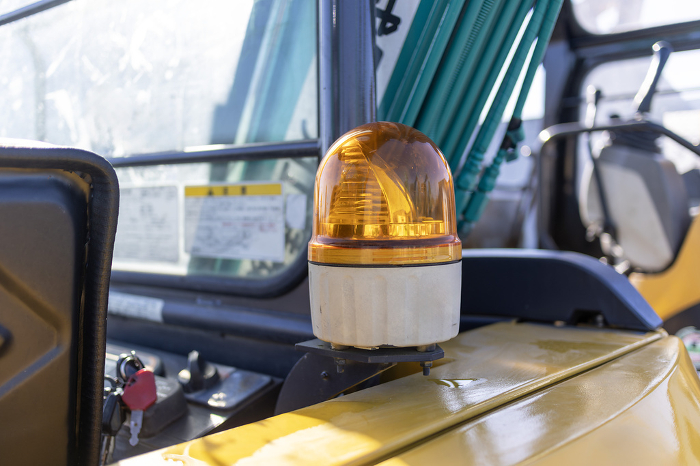 Yellow revolving light installed on the back side of heavy equipment