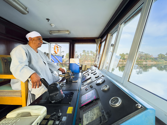 Egyptian Captain of the Oberoi Philae at the helm on the Nile River, Dendera, Egypt, North Africa, Africa Egyptian Captain of the Oberoi Philae at the helm on the Nile River, Dendera, Egypt, North Africa, Africa, by Michael Nolan