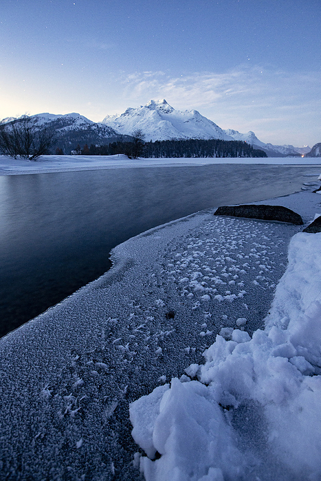 Winter sunrise over the frozen surface of Lake Sils in winter, Engadine, Canton of Graubunden, Switzerland, Europe Winter sunrise over the frozen surface of Lake Sils in winter, Engadine, Canton of Graubunden, Switzerland, Europe, by Roberto Moiola