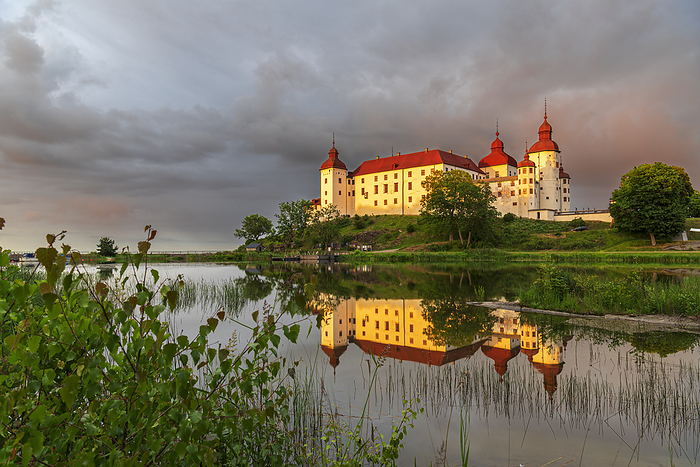Lacko Castle and the reflection in the water at sunset, Kallandso island, Vanern lake, Vastra Gotaland, Sweden, Scandinavia, Europe Lacko Castle and the reflection in the water at sunset, Kallandso island, Vanern lake, Vastra Gotaland, Sweden, Scandinavia, Europe, by Paolo Graziosi