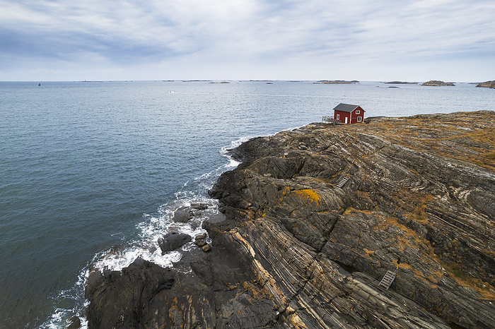 Lone red house surrounded by sea on top of a cliff of a rocky island, Bohuslan, Vastra Gotaland, West Sweden, Sweden, Scandinavia, Europe Lone red house surrounded by sea on top of a cliff of a rocky island, Bohuslan, Vastra Gotaland, West Sweden, Sweden, Scandinavia, Europe, by Paolo Graziosi