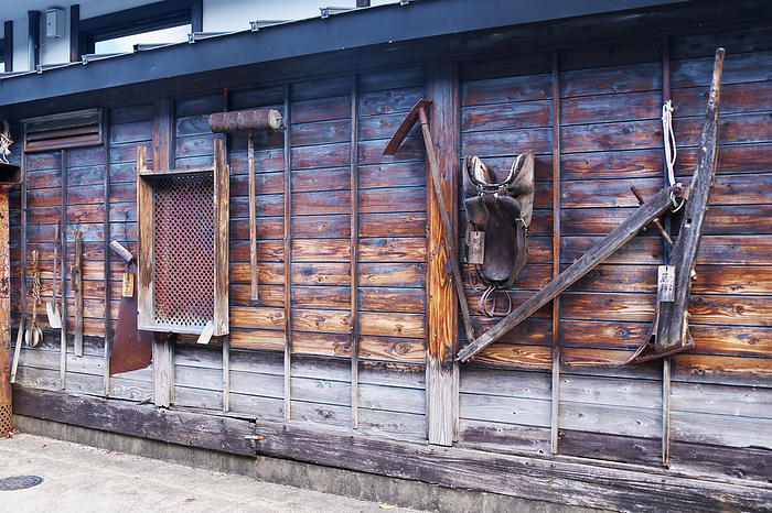 Farming tools displayed on the exterior wall of the Tsugaru Folklore Crafts Museum, Aomori Pref.