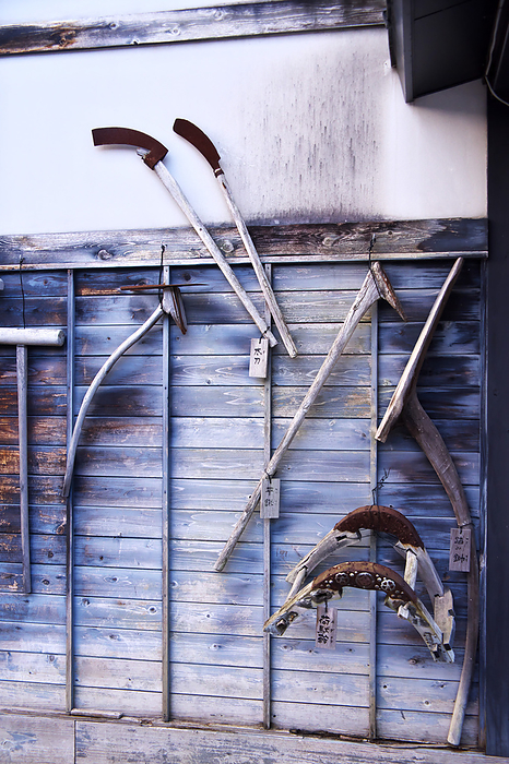 Farming tools displayed on the exterior wall of the Tsugaru Folklore Crafts Museum, Aomori Pref.