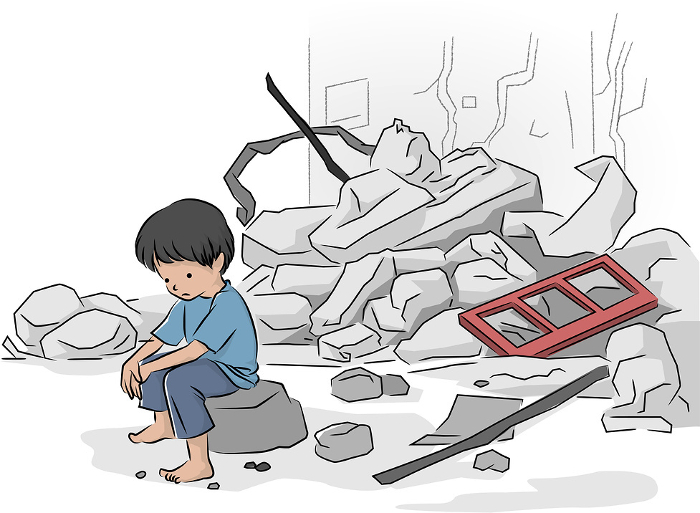 A child sitting in the rubble