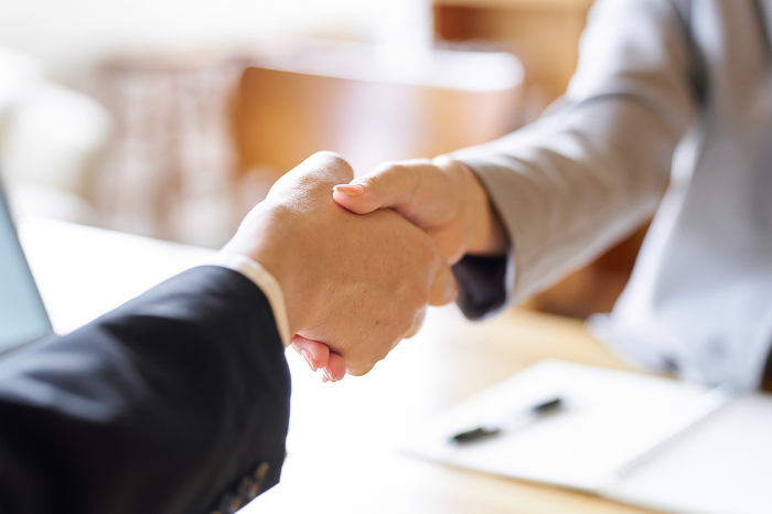 Business people shaking hands at a meeting.