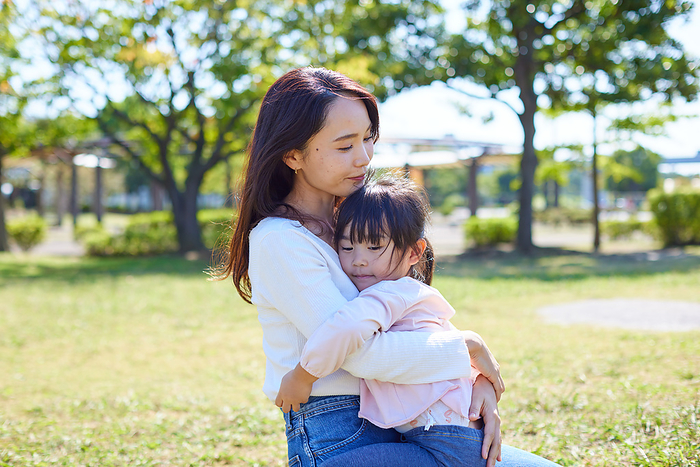 Japanese girl being carried by her mother