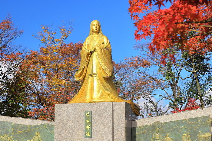 Statue of Murasaki Shikibu looking at Murasaki Shikibu Park and Mt. Hino in autumn leaves, Echizen City, Fukui Prefecture
