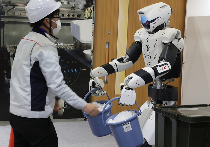 Robot makers display their katest products at the International Robot Exhibition November 30, 2023, Tokyo, Japan   Japan s Kawasaki Heavy Industries demonstrates a humanoid robot  RHP Kaleido  to receive buckets from a human at the International Robot Exhibition 2023 in Tokyo on Thursday, November 30, 2023.    photo by Yoshio Tsunoda AFLO 