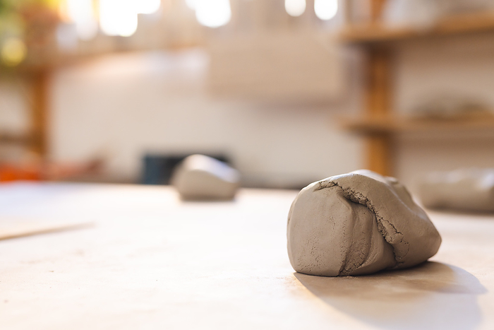 Close up of clay lying on desk in pottery studio. Pottery, ceramics, handmade, local business, hobbies and craft.