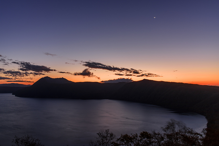 Lake Mashu and crescent moon before dawn, Hokkaido