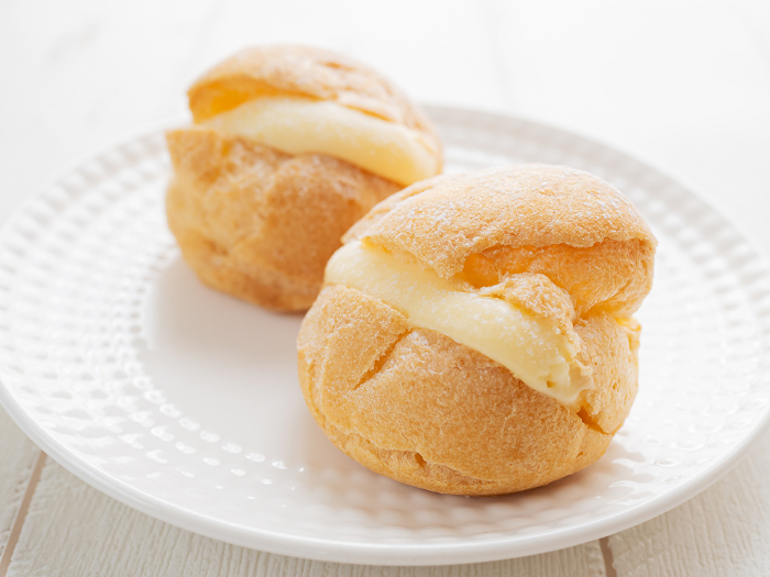 Two cream puffs on a plate
