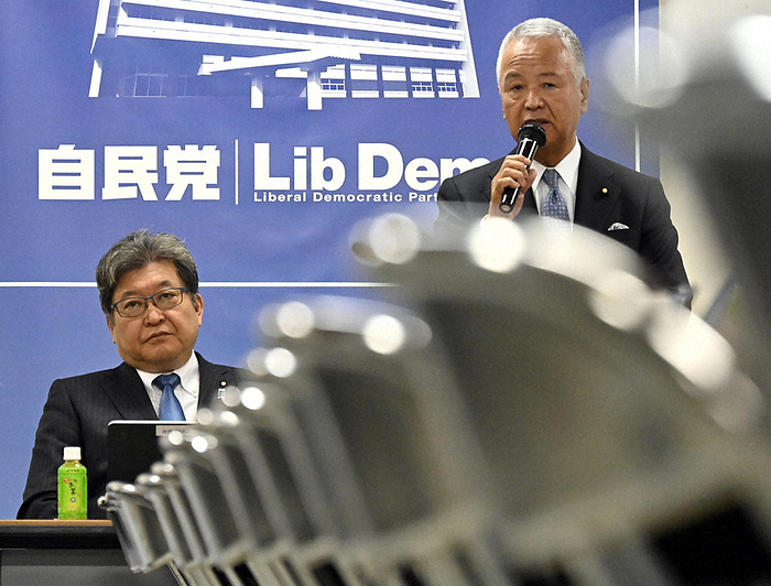 Akira Amari, chairman of the LDP s  Project Team to Study the NTT Law  speaks at a meeting of the LDP. At left is Koichi Hagiuda, Chairman of the Policy Research Council of the Liberal Democratic Party. Akira Amari  right , chairman of the LDP, speaks at the LDP s  Project Team to Study the NTT Law. On the left is Koichi Hagiuda, Chairman of the Policy Research Council of the Liberal Democratic Party  LDP .