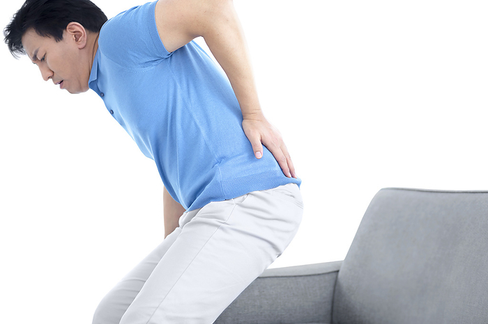 Man with lower back pain Man with lower back pain., by SCIENCE PHOTO LIBRARY