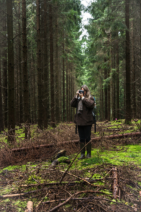 Woman Shooting Photos With Vintage Camera In The Forest in Denmark, by Cavan Images / Emily Wilson Photography