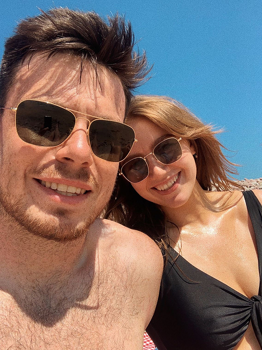 Sarah McKernan Stock Portfolio Couple s beach selfie on a sunny day, capturing beach love, by Cavan Images   Sarah McKernan