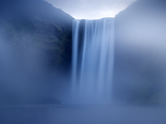 Iceland landscape covered by fog at Skogafoss waterfall Iceland landscape covered by fog at Skogafoss waterfall, by Cavan Images   David Santiago Garcia