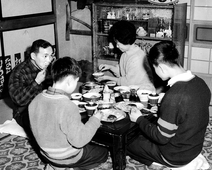 A Family Around the Table  1962  A family in the 1950s gathered around the dining table, photographed in 1962.