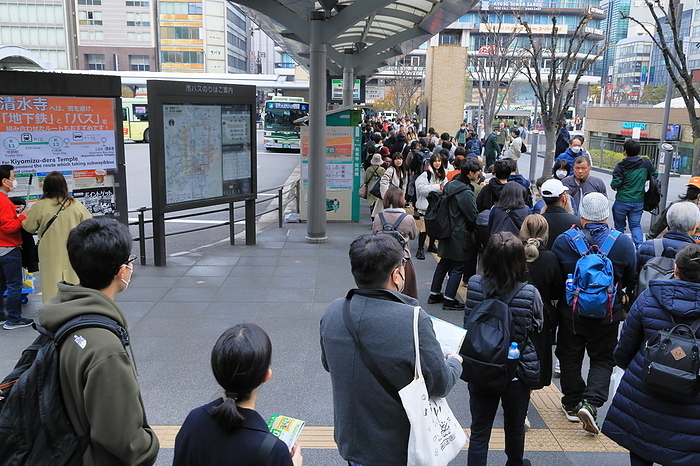 People queuing at the bus stop in front of JR Kyoto Station for the city bus bound for Higashiyama, Kyoto City, Kyoto Prefecture.