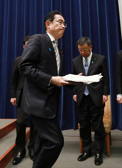 Prime Minister Kishida holds a press conference to explain the political fund issue, etc. Prime Minister Fumio Kishida  foreground  leaves the venue after the press conference. At the back right is Chief Cabinet Secretary Hirokazu Matsuno at the Prime Minister s Office at 7:08 p.m. on December 13, 2023  representative photo .