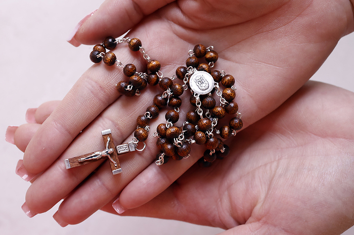 Woman s hands holding wood Catholic rosary in prayer, Vietnam, Indochina, Southeast Asia, Asia Woman s hands holding wood Catholic rosary in prayer, Vietnam, Indochina, Southeast Asia, Asia, by Godong