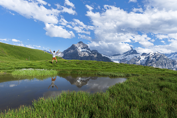 Happy hiker reflecting in the water of a small lake below the Bernese Oberland mountains, Bachalpsee, Grindelwald, Bern canton, Switzerland, Europe Happy hiker reflecting in the water of a small lake below the Bernese Oberland mountains, Bachalpsee, Grindelwald, Bern canton, Switzerland, Europe, by Paolo Graziosi