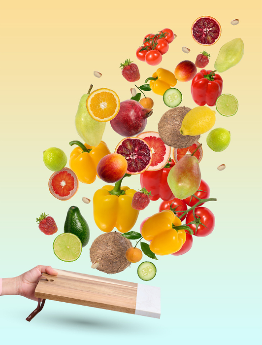 Levitating fruits and vegetables over a wooden kitchen board. Healthy eating Levitating fruits and vegetables over a wooden kitchen board. Healthy eating