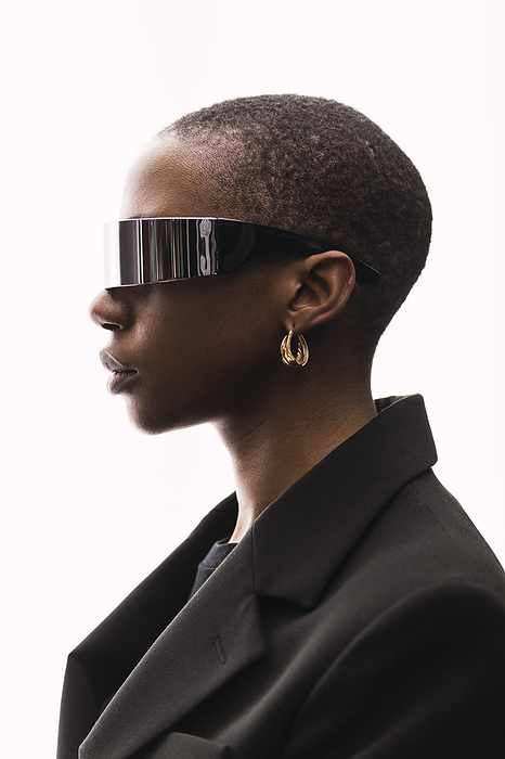 Contemplative woman with smart glasses against white background