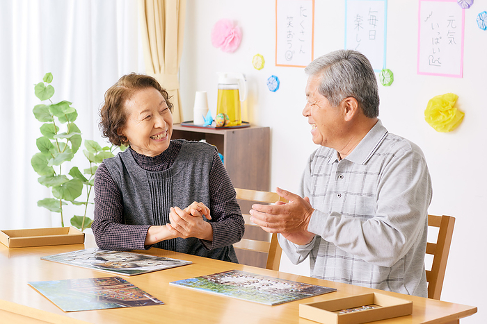A Japanese senior couple doing a puzzle