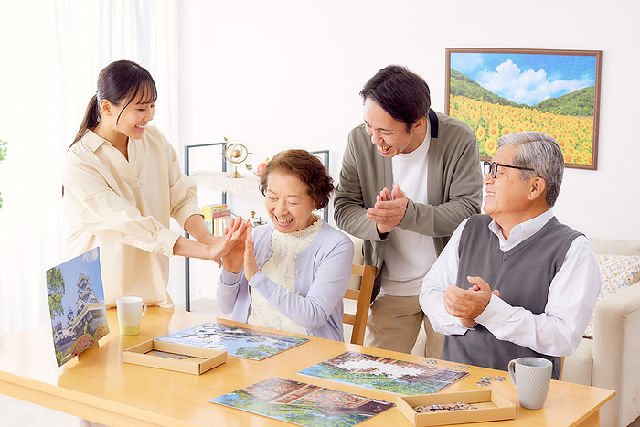Japanese family doing a puzzle in the living room