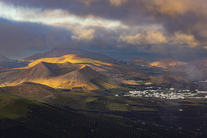 Spain, Canary Islands, La Geria, View from Montana de Guardilama volcano at cloudy dawn