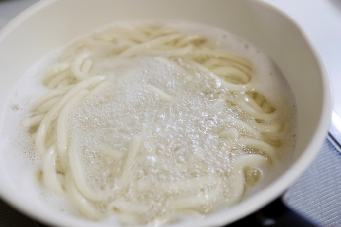 Sanuki udon noodles are boiled in a pot.