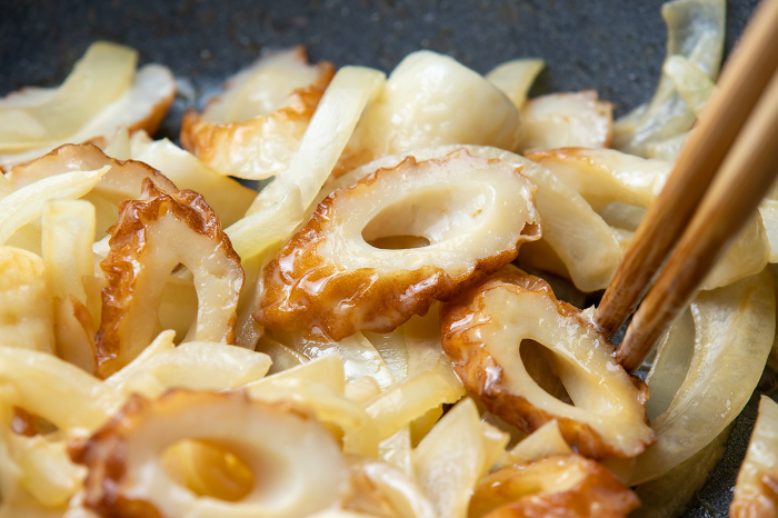 Fried bamboo rings and onions, close-up of the cooking scene.