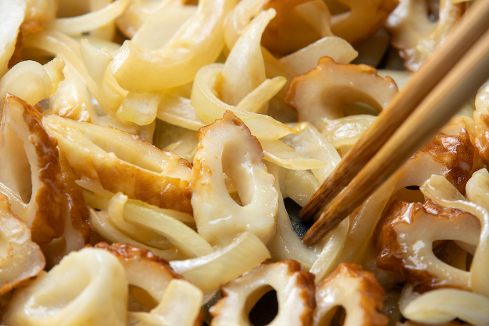 Fried bamboo rings and onions, close-up of the cooking scene.
