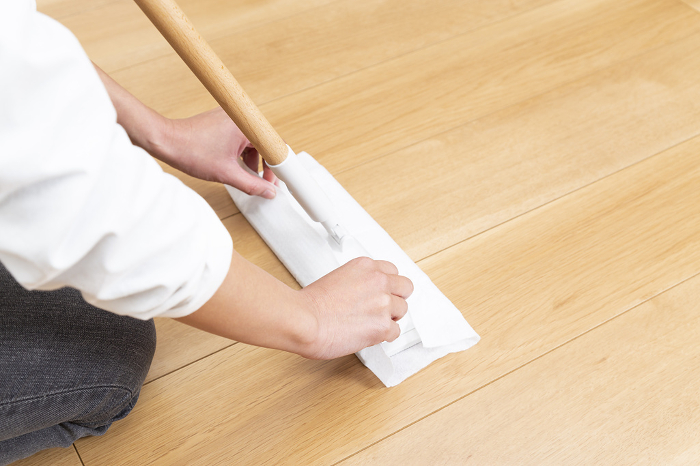 Woman's hand changing a sheet of flooring wiper.