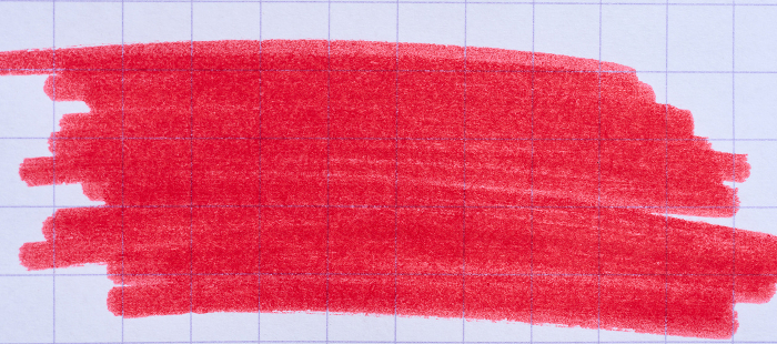 Hatching with a red felt tip pen on a sheet of checkered paper Hatching with a red felt tip pen on a sheet of checkered paper