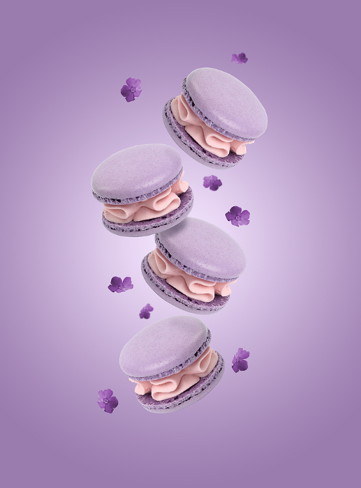 Purple macarons levitate on a purple background, gourmet dessert Purple macarons levitate on a purple background, gourmet dessert