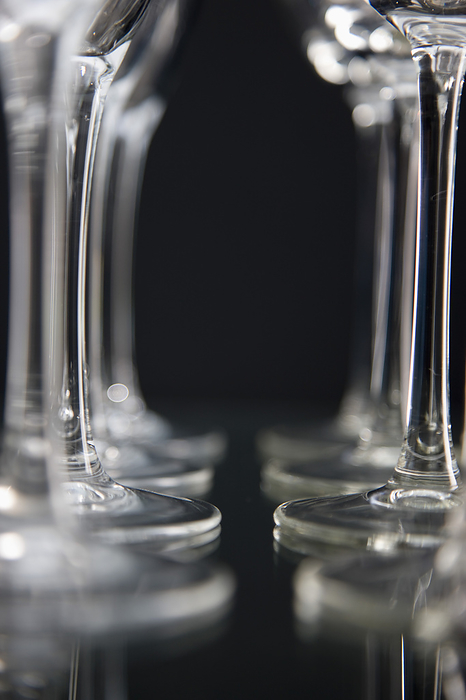 Extreme close up of empty wine glasses lined up, by Ableimages