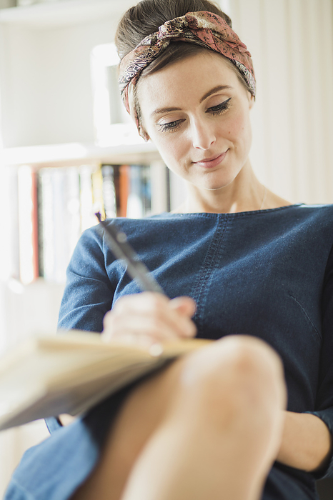 Woman Writing on Notebook, by Jutta Klee