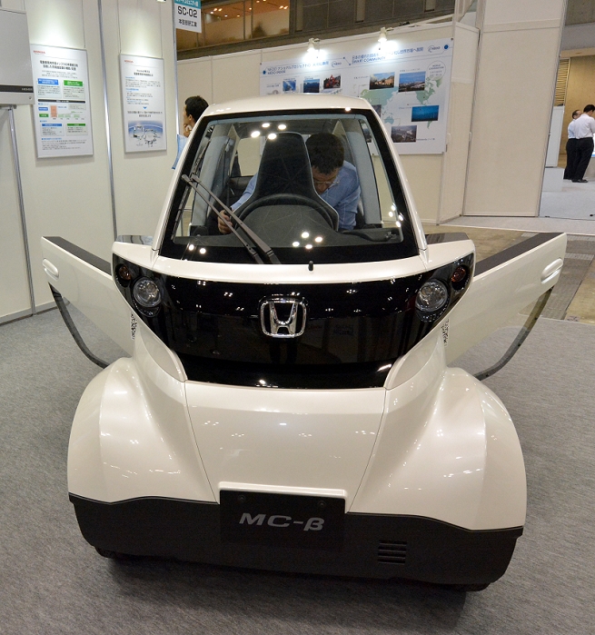 Smart Community A Comprehensive Exhibition on New Urban Development June 18, 2014, Tokyo, Japan   A Honda s two seater electric vehicle is being demonstrated during the Smart Community Exhibition in Tokyo on Wednesday, June 18, 2014. The vehicle has been used in the Honda Smart Home System, an experimental  house which controls in house energy supply and demand, and helps manage both the generation and consumption of energy for the home such as heat and electricity, while utilizing mobility products. The exhibition, proposing new technologies and solutions for construction of social infrastructure showcased houses, building, factories, stores and all kinds of products or technologies relating to the smart community.   Photo by Natsuki Sakai AFLO  AYF  mis 