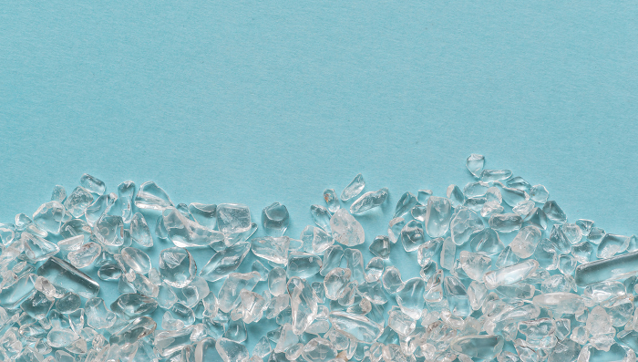 Crystal pebbles on blue background