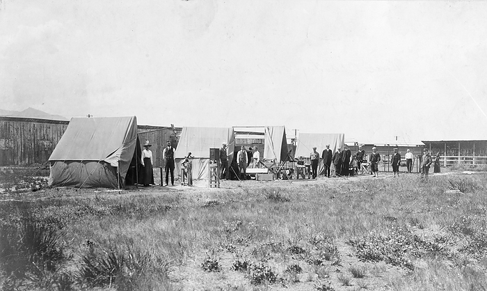 US Naval Observatory Total Solar Eclipse Expedition, 1918 US Naval Observatory Total Solar Eclipse Expedition, in Baker, Oregon, USA, ready for the total solar eclipse of the 8th June 1918. It was hoped that observations from this eclipse would confirm Einstein s theory of general relativity. If correct the stars near the Sun would appear slightly shifted because their light would be curved by its gravitational field. This shift is only noticeable during a solar eclipse as at other times the Sun s brightness obscures the stars. However, cloud cover at the moment of totality prevented observation of the stars. Einstein s theory was confirmed with observations from the solar eclipse of 29th May 1919., by US NAVY SCIENCE PHOTO LIBRARY