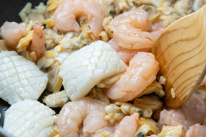 Cooking scene of pan-frying shrimp, shrimps and scallions with shrimps.