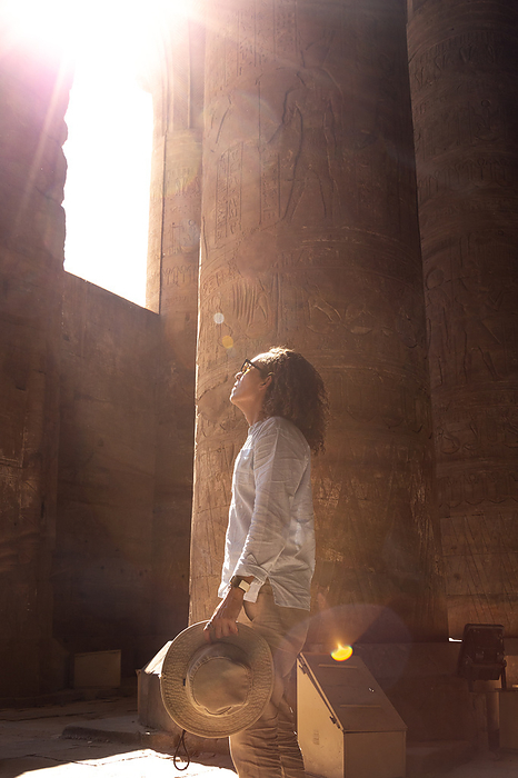 Young male tourist exploring the Edfu Temple, Egypt, by Cavan Images / Marco Rof